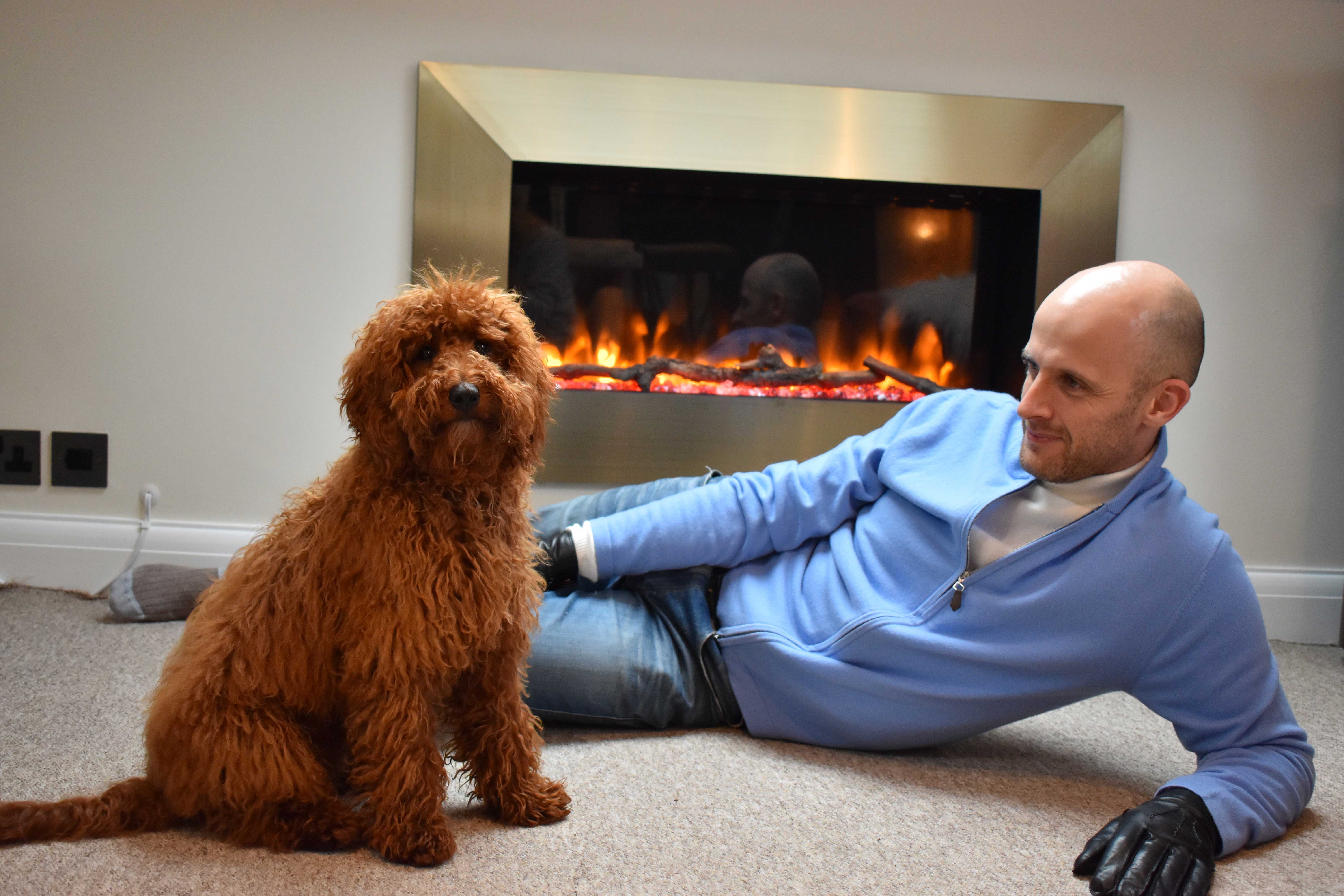 Me posing by fireplace with Roger the dog 