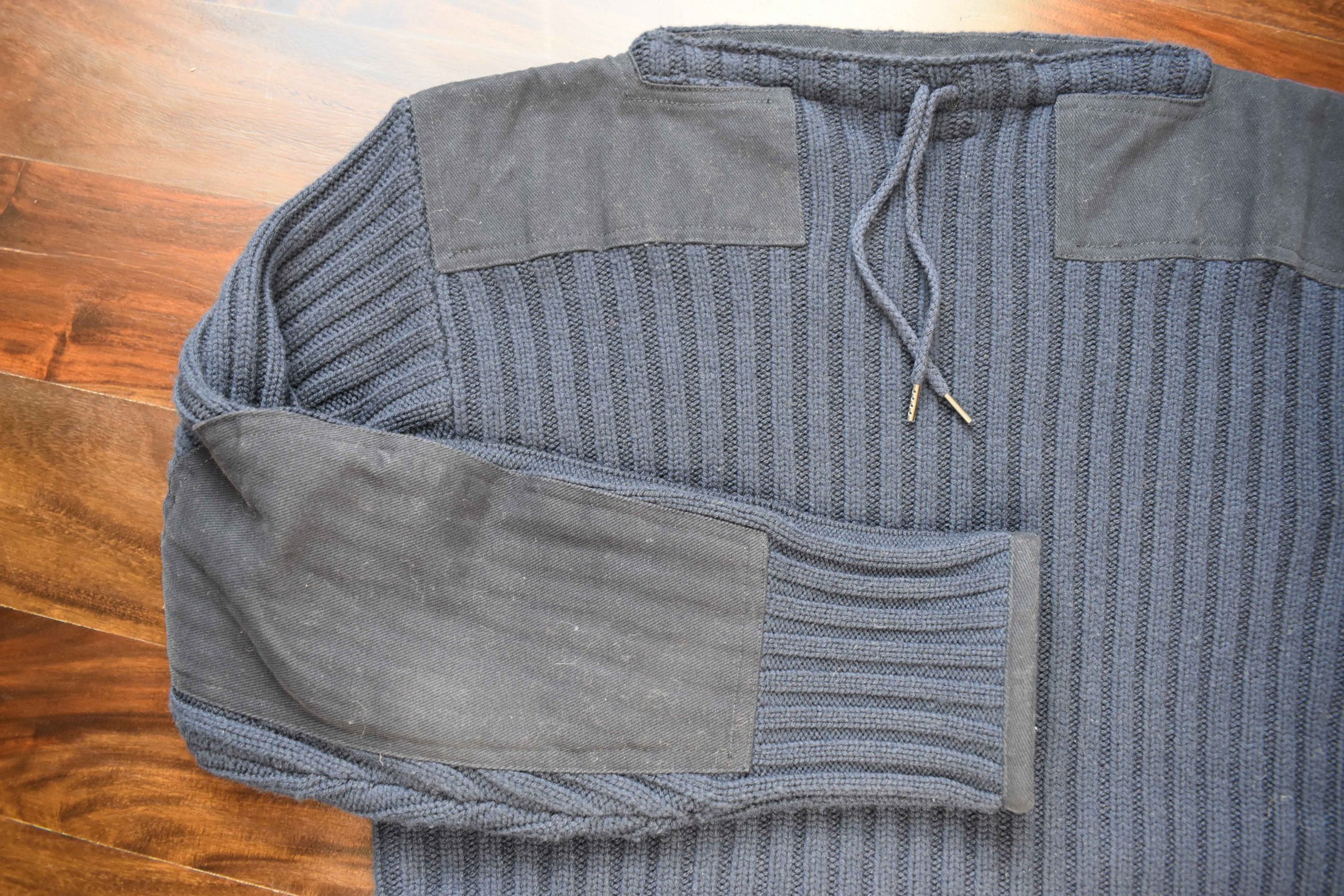 Army sweater flat lay