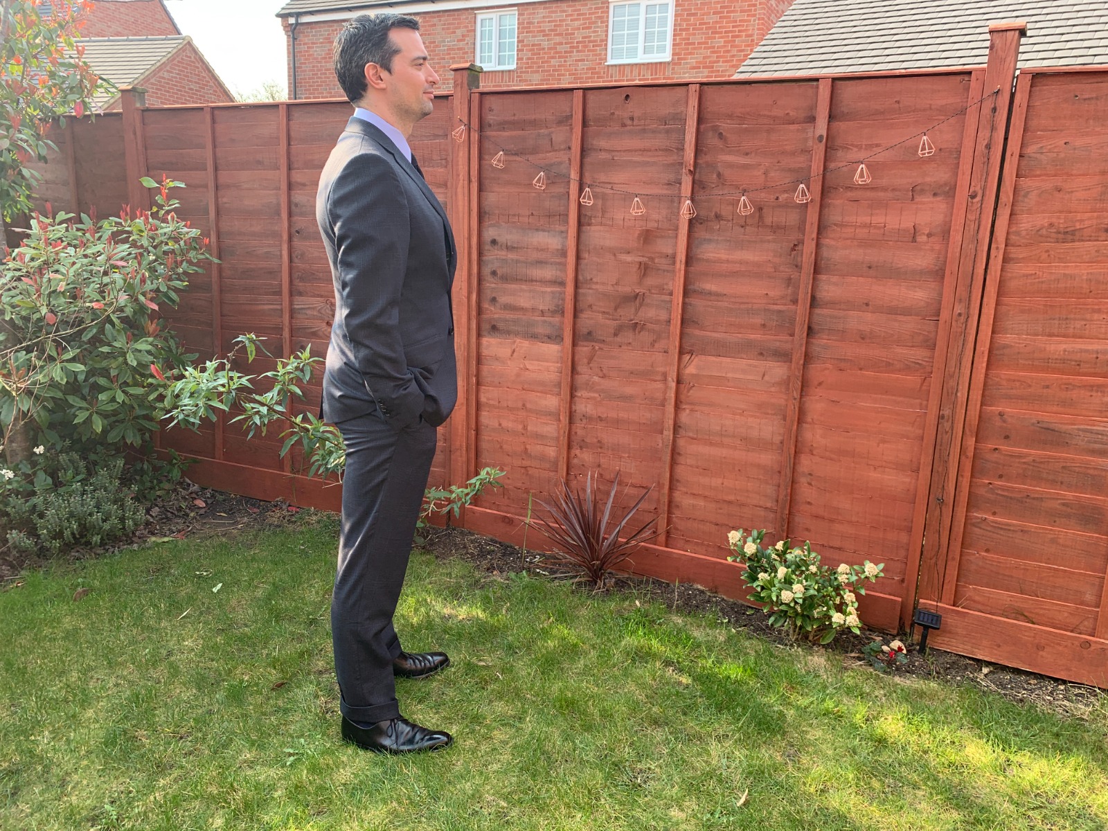 Daniel Gaster wearing a Navy Prince of Wales Tom Ford suit in his garden 