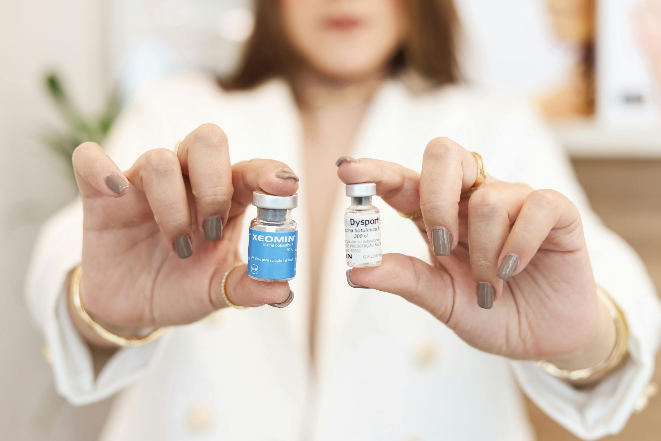 Alt: Researcher holding two vials, courtesy of Hannah Barata on Pexels